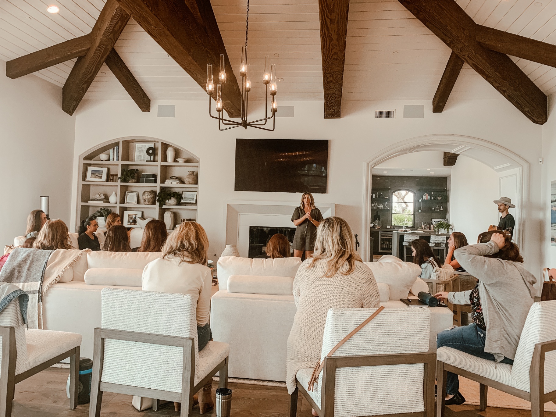 Marissa teaching in a beam-ceiling living room