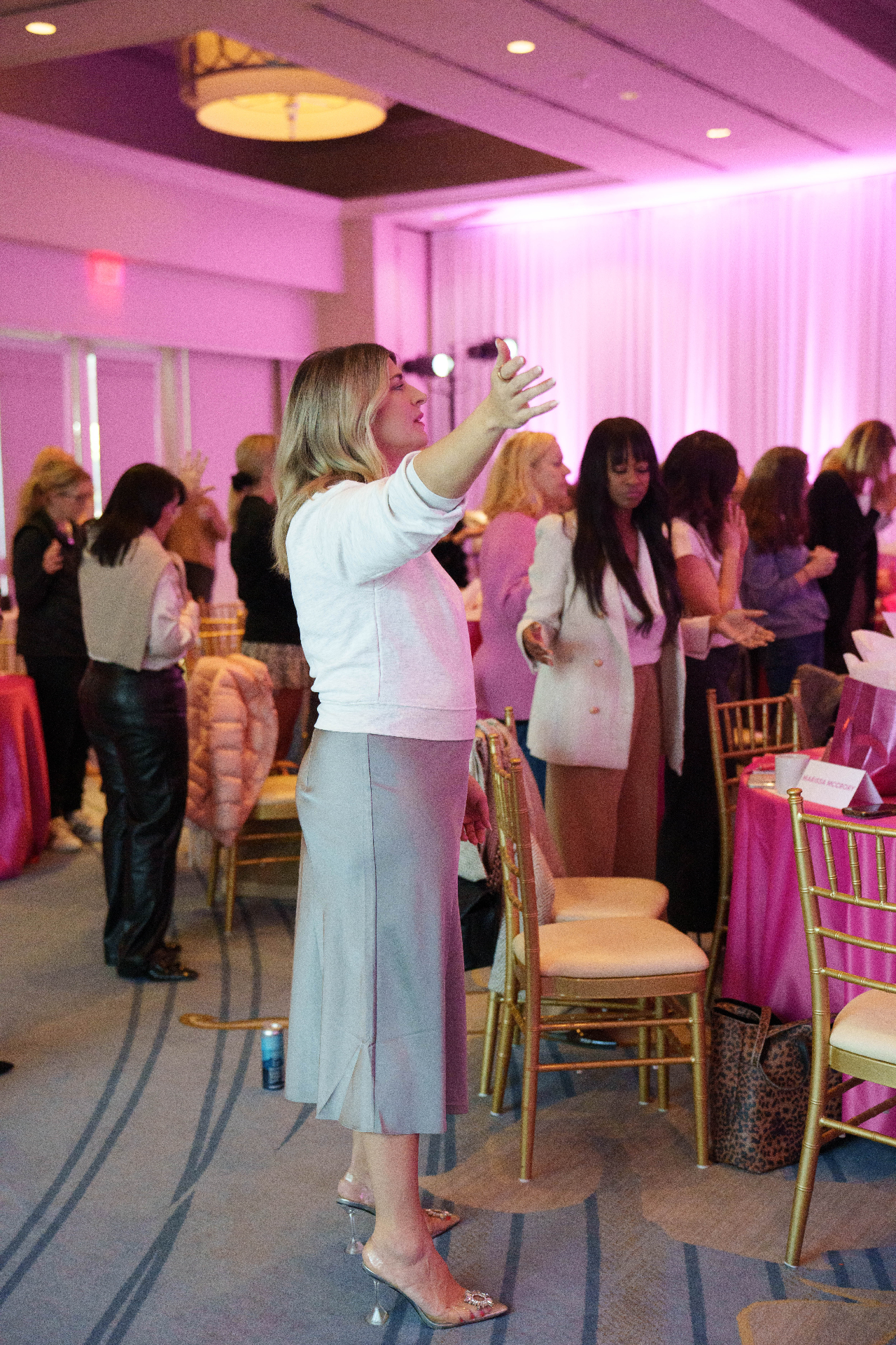Women in worship at a Healing Her retreat