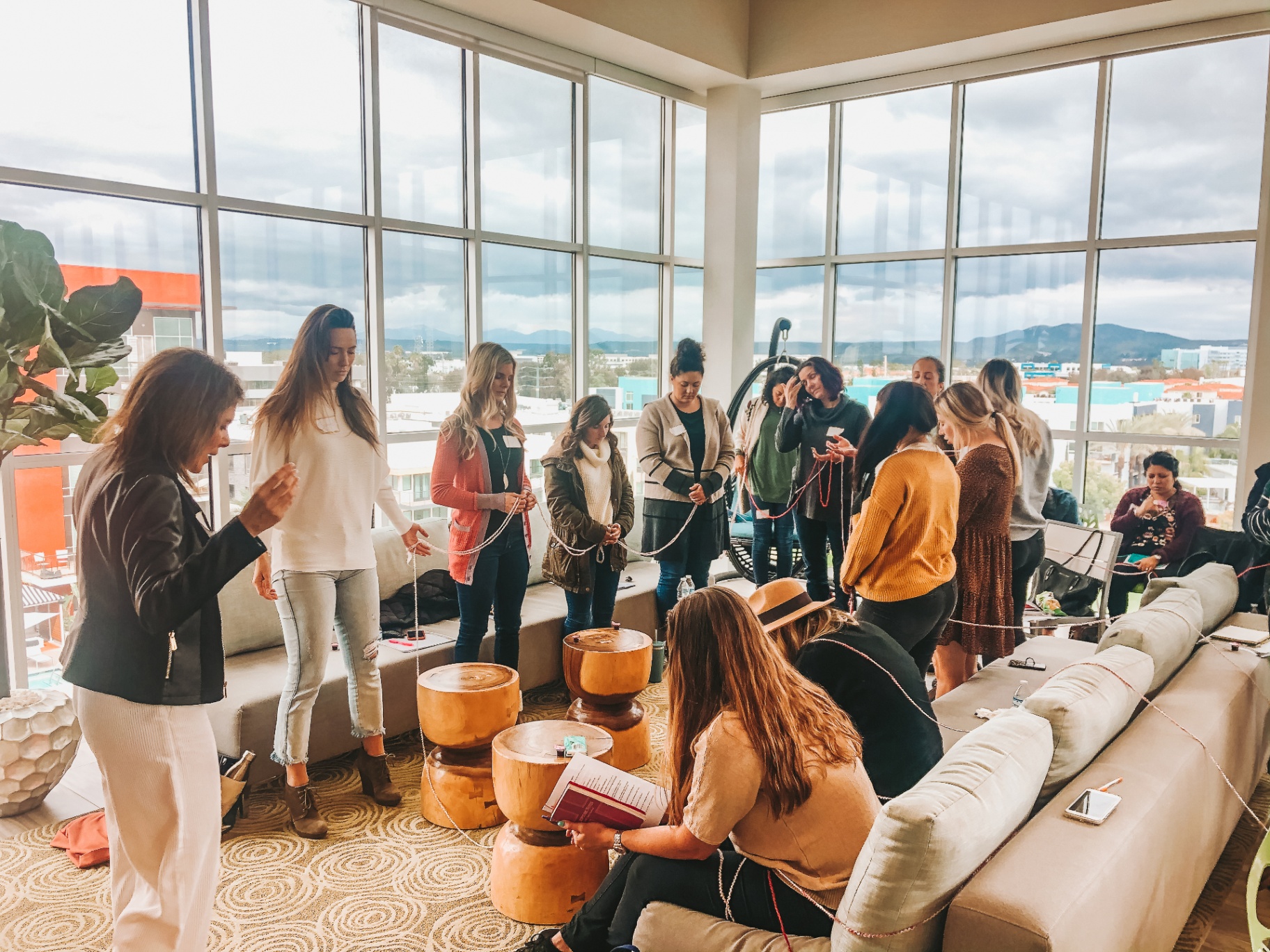 Women in a cord-tying ceremony at a Healing Her retreat