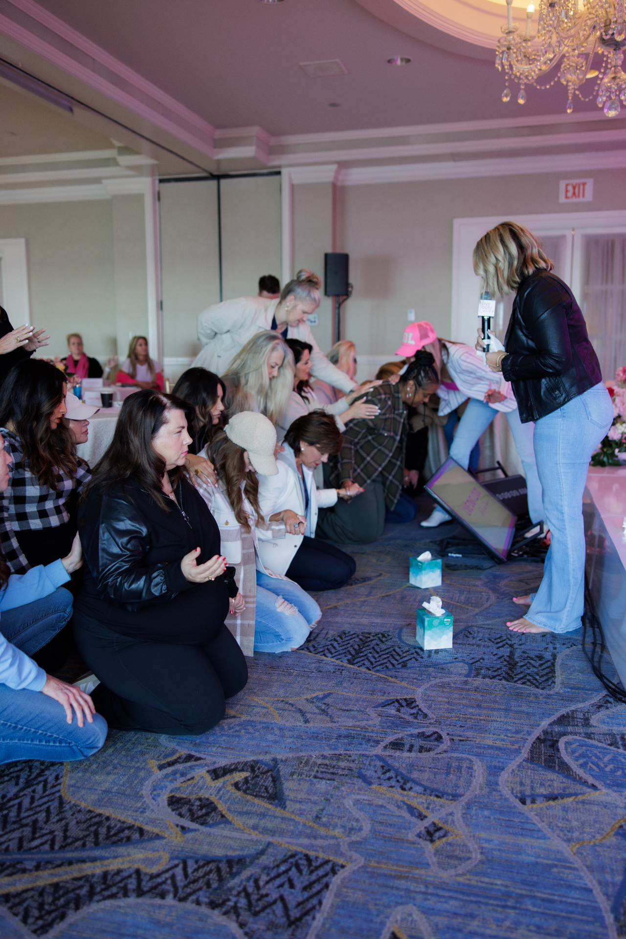 Women praying together at a Healing Her retreat