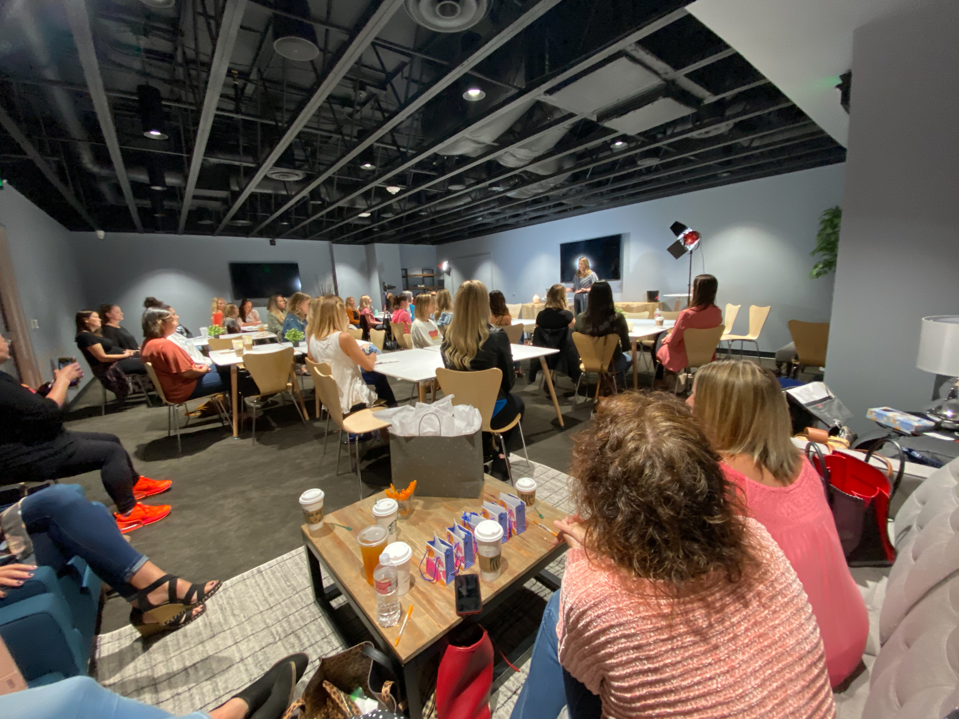 Women listening to a speaker in a classroom setup