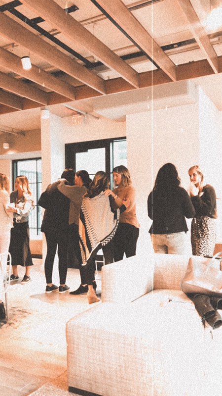 Women embracing after a workshop session